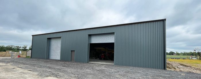 West Sussex grain store steel-frame building exterior showing double entrance with roller shutter doors