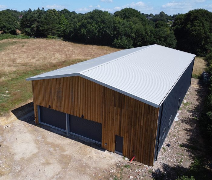 An aerial view of Beacon Down Vineyard's new winery building showing roof and timber cladding