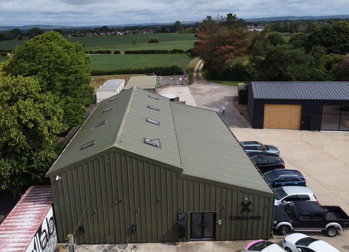 A large office industrial building recently reclad in green on a rural industrial estate