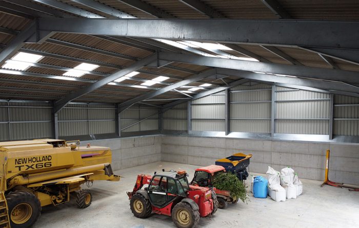 Interior of the steel-framed grain store showing the power floated floor, skylights and spill boards